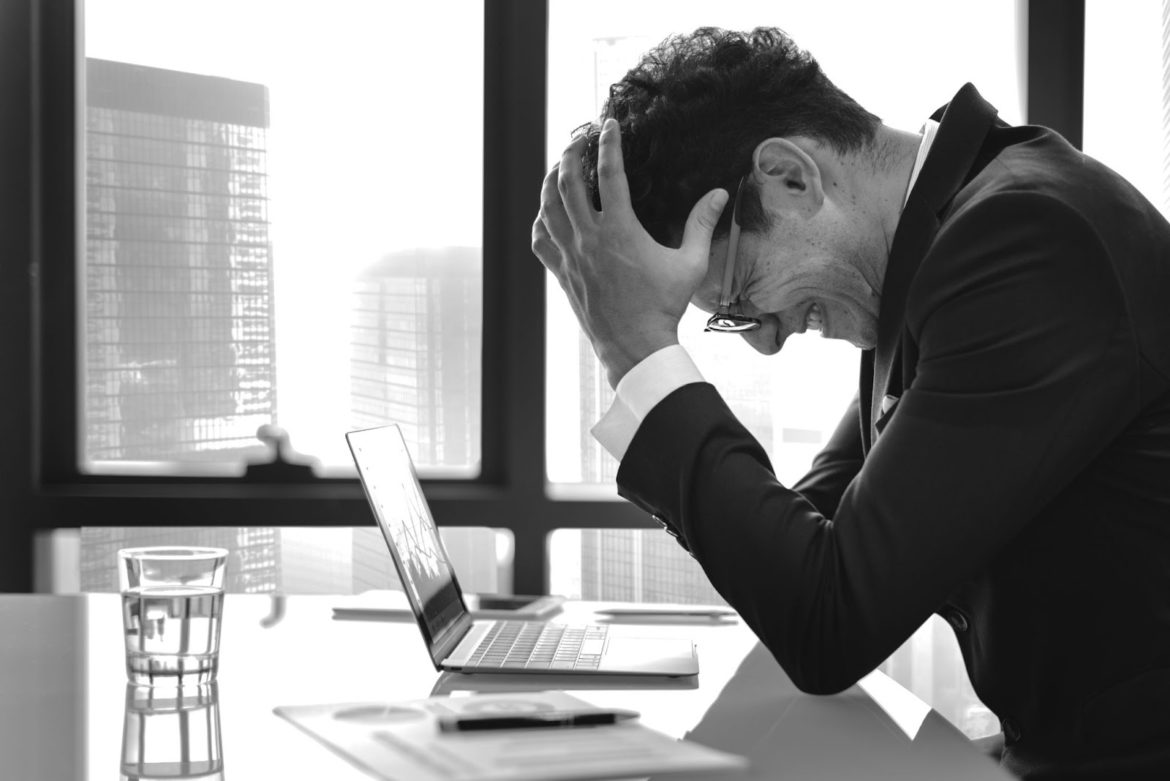 person stressed out facing business management crisis
