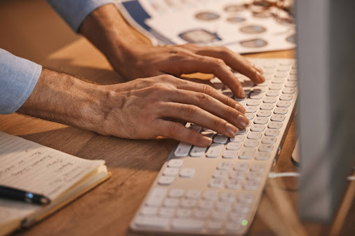 worker typing on a keyboard
