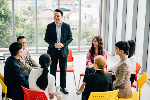 a group of business man and woman talking in a circle