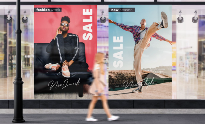 A woman walking past large promotional posters on the streets